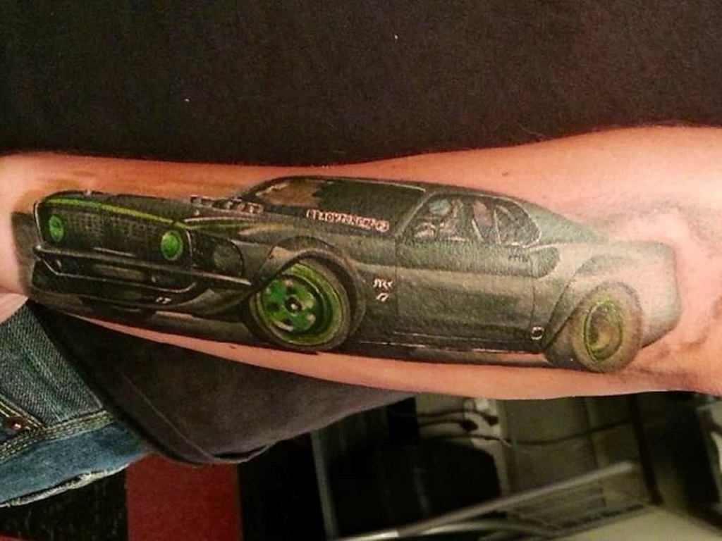 green-wheels-car-tattoo-on-arm-for-guys