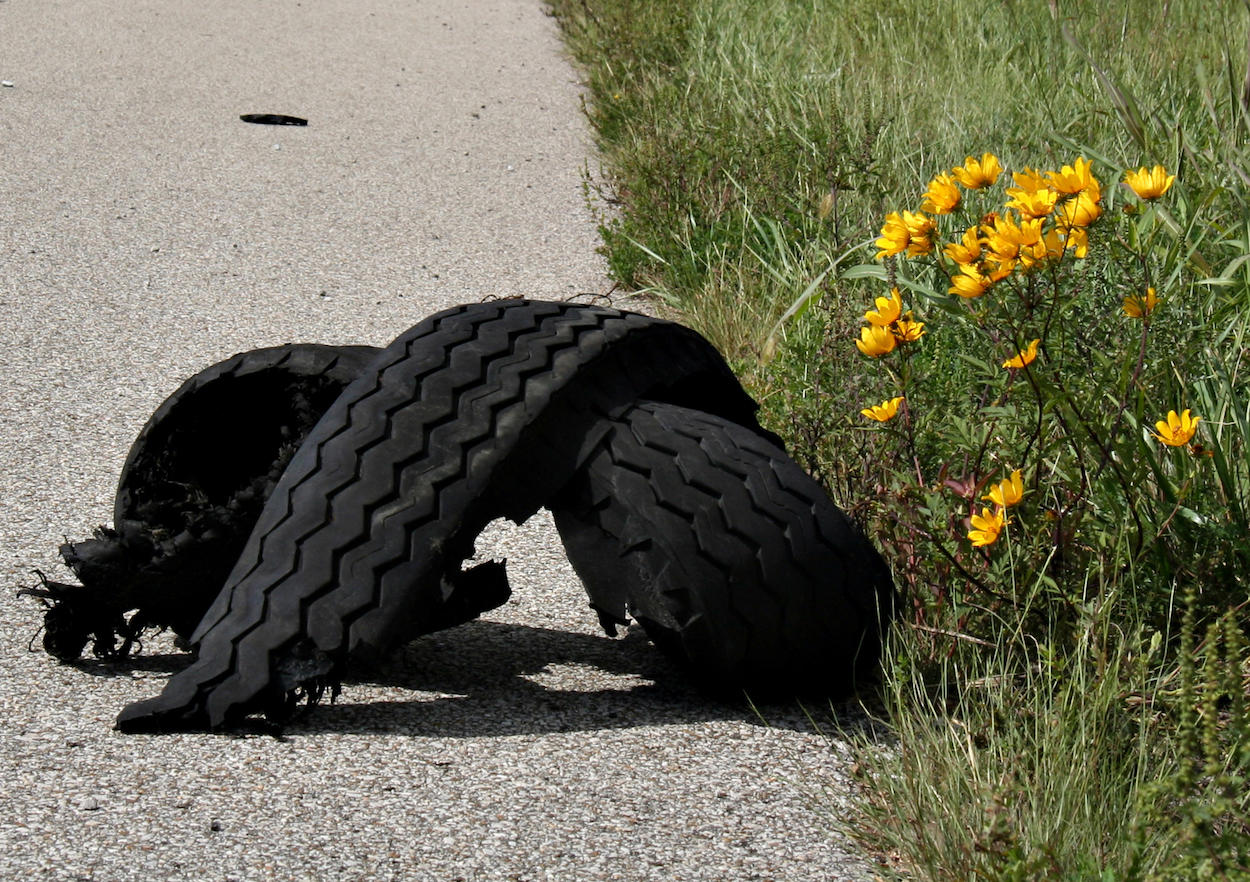 Shredded tire on the shoulder of the highway