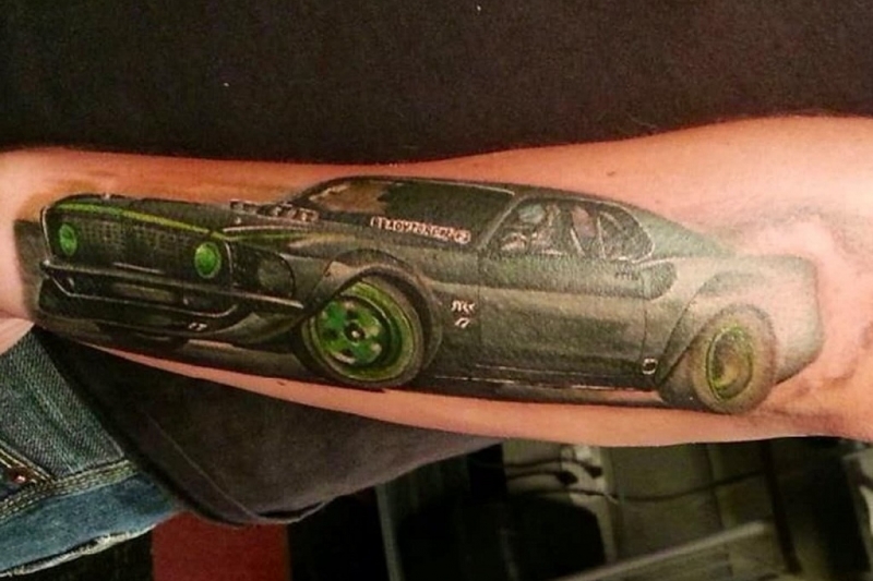 green-wheels-car-tattoo-on-arm-for-guys