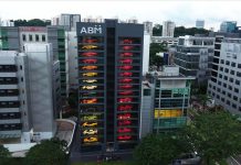 Um stand num arranha-céus com Ferraris e Lamborghinis na montra