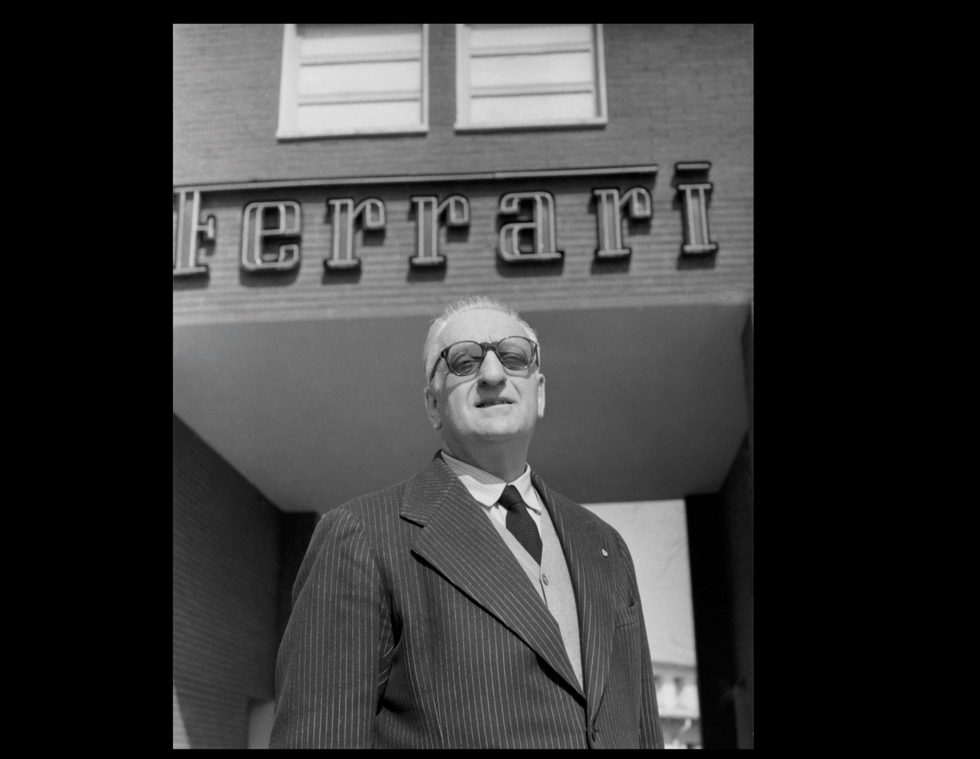 7.-Enzo-Ferrari-at-the-entrance-of-the-Ferrari-Factory,-1957