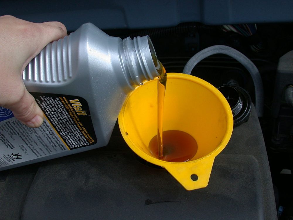Motor_oil_refill_with_funnel