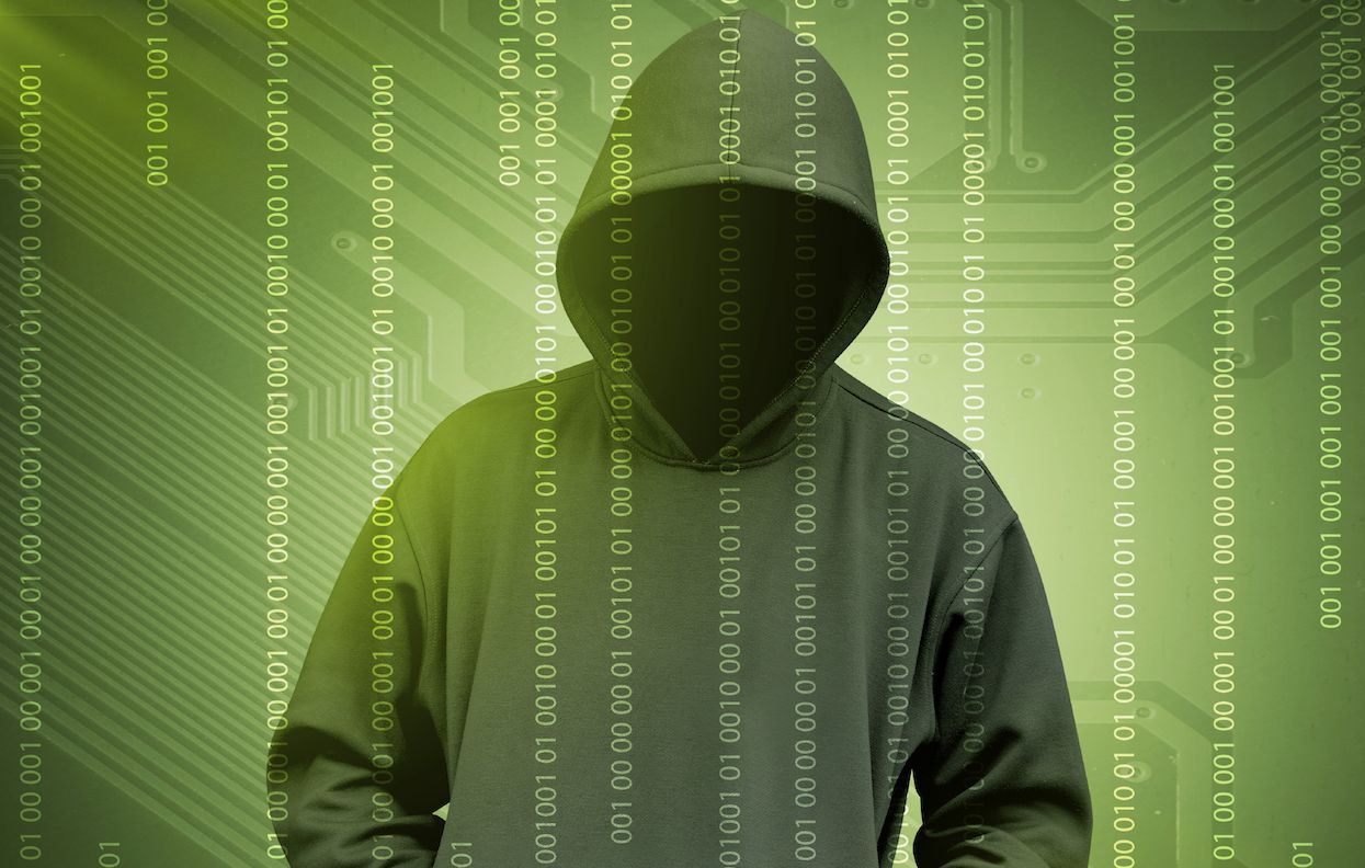 Computer hacker silhouette of hooded man