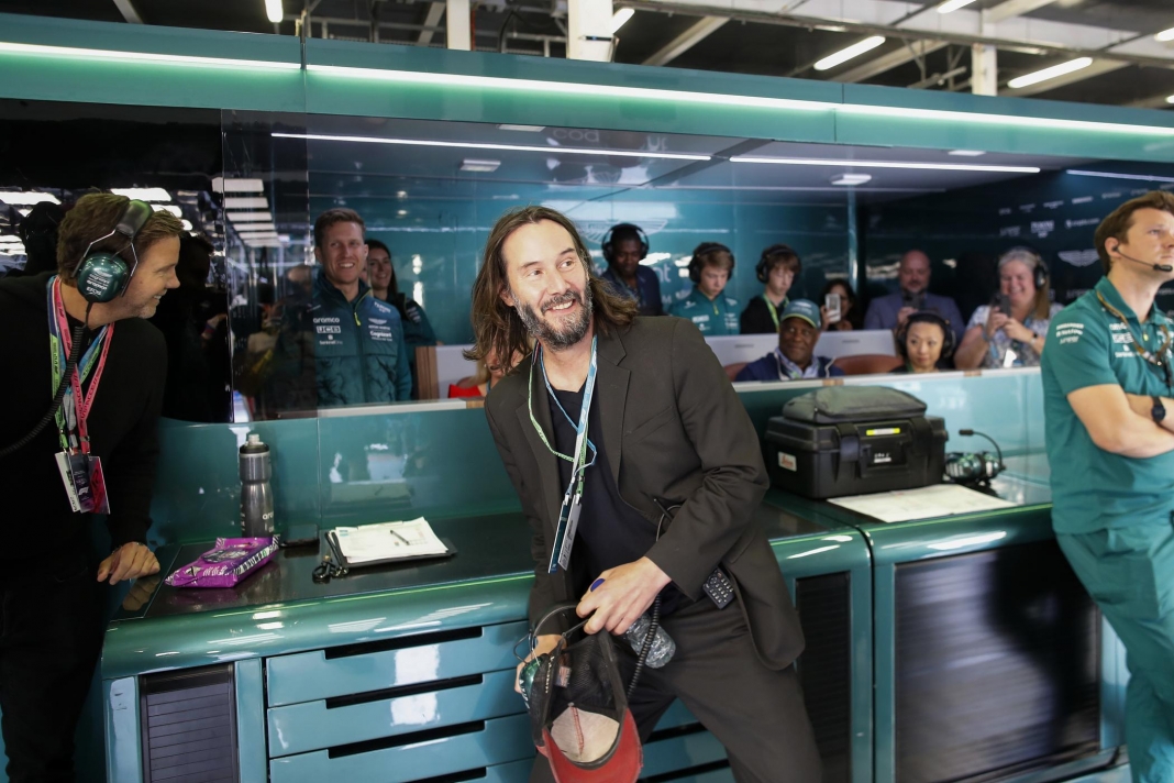 Actor Keanu Reeves in the Aston Martin garage